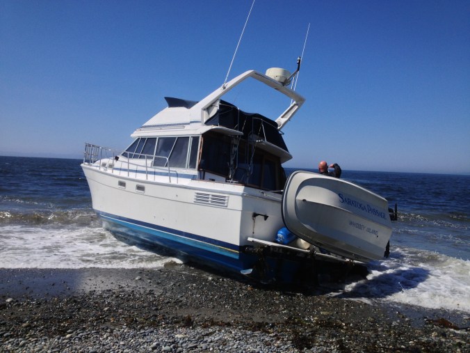 Stranded boat being towed off of Dungeness Spit
